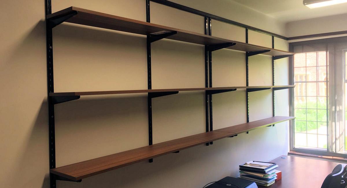 Dark Walnut wooden shelf supply, delivery and installation at the China Centre, Jesus College in Cambridge to match existing furniture.