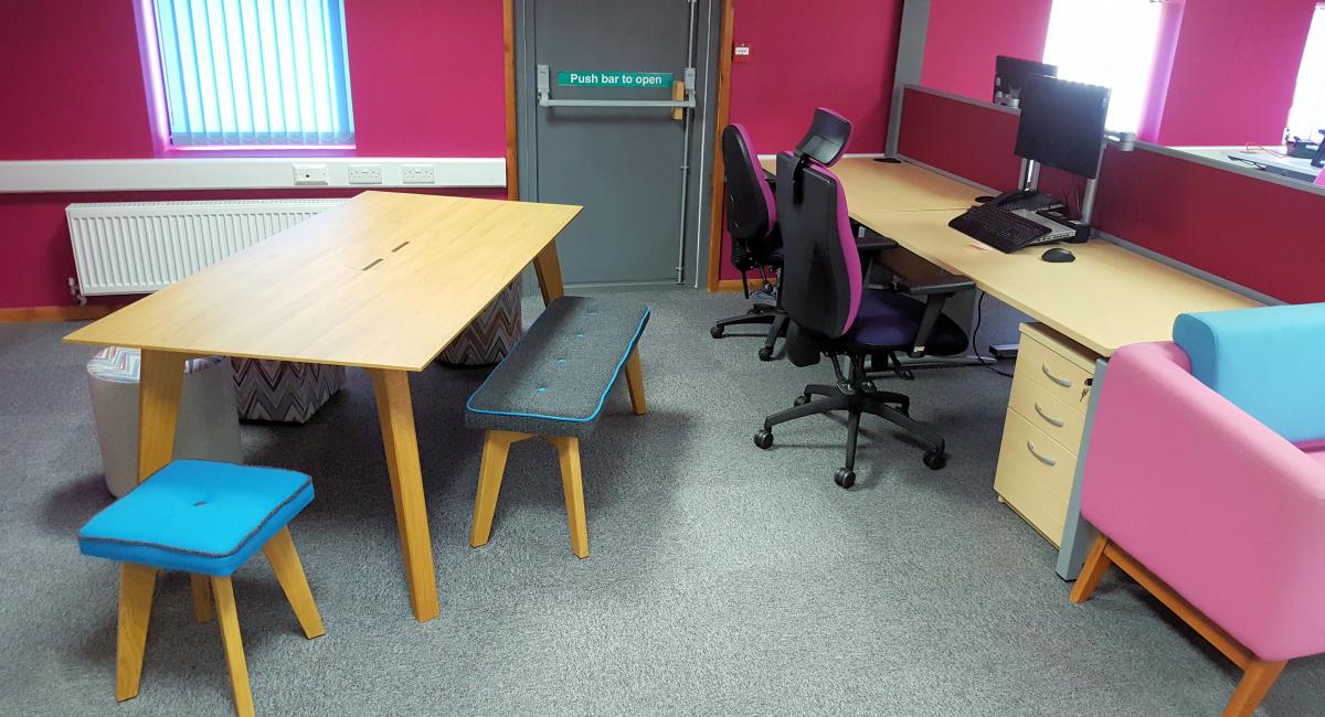 Breakout soft seating and stools, partnered with complimentary wooden tables.