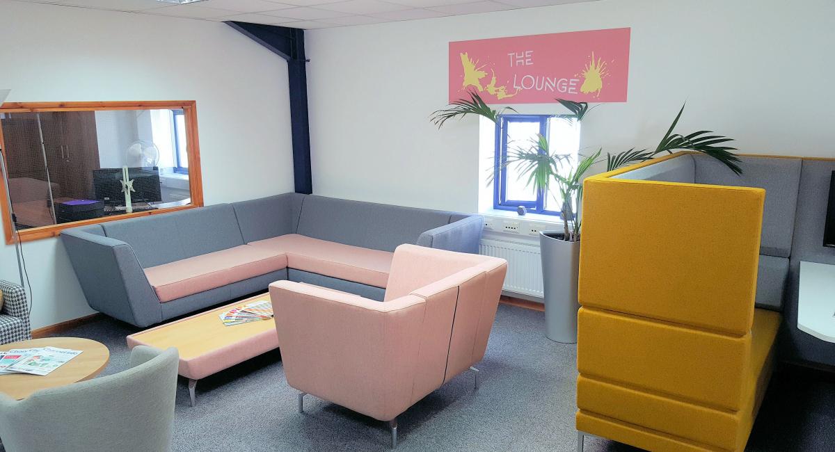Stylish soft seating including single booth style chair and modular pod unit finished in pink fabric.