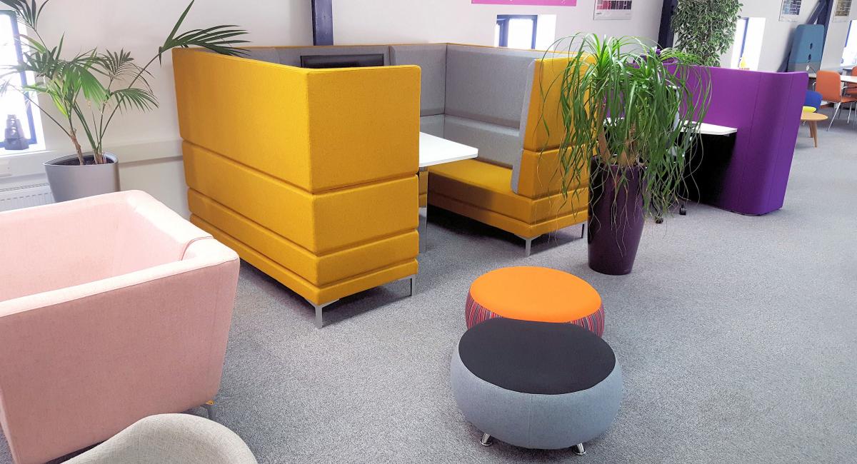 Breakout booths with highbacks  finished in mustard yellow fabric and perfect for informal meetings.