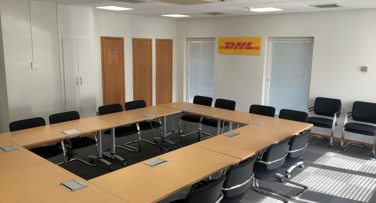 Boardroom furniture refurbishment with tilt top table tops, partnered with black cantilever frame chairs.