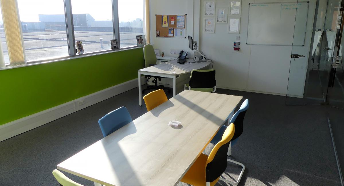 Meeting Room Table finished in Nordic Ash finish with cantilever frame meeting chairs.