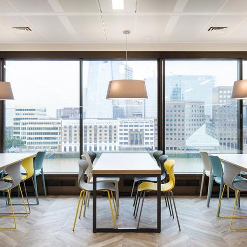 White Bench tables with black steel loop frames partnered with vibrant polypropylene chairs.